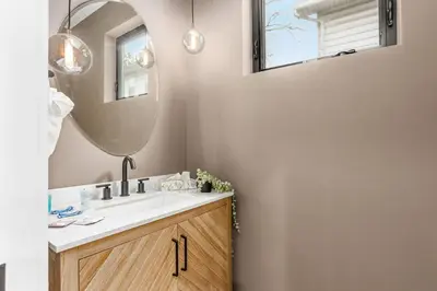 a bathroom with a sink and a mirror at Stylish 4BR in Merion Village PD in Columbus