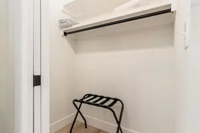 a black chair sits in front of a closet at Stylish 4BR in Merion Village PD in Columbus