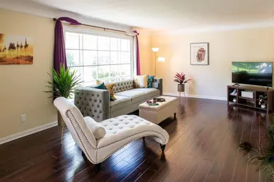 a living room with a couch and a tv at The Italian Farmhouse in Cleveland Heights