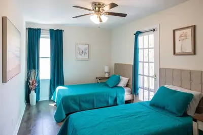 a bedroom with two beds and a ceiling fan at The Italian Farmhouse in Cleveland Heights