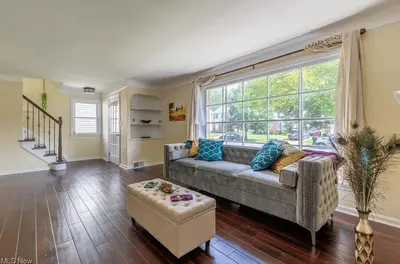 a living room with a couch and a large window at The Italian Farmhouse in Cleveland Heights