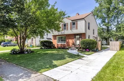 a house with a tree in the yard at The Italian Farmhouse in Cleveland Heights