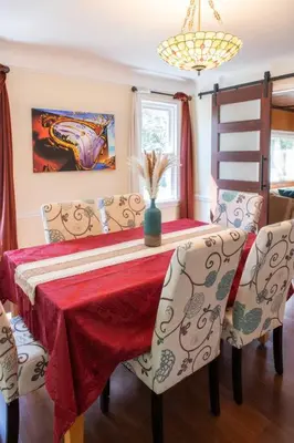 a dining room table with a red table cloth and chairs at The Italian Farmhouse in Cleveland Heights