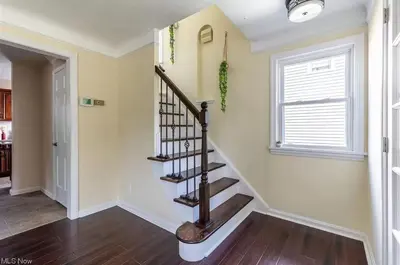 a spiral staircase in a home with a window at The Italian Farmhouse in Cleveland Heights