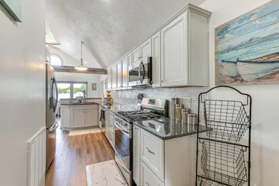 a kitchen with white cabinets and a counter top at Waterfront with Boat Dock Retreat on Indian Lake in Lakeview