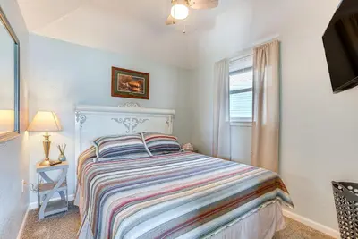 a white bedroom with a bed and a window at Waterfront with Boat Dock Retreat on Indian Lake in Lakeview