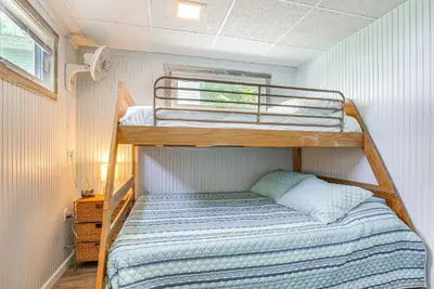 a bedroom with a bunk bed in a tiny house at Waterfront with Boat Dock Retreat on Indian Lake in Lakeview