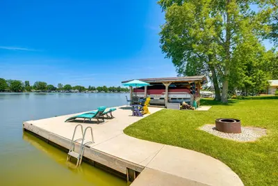 a dock with a gazebo on the side of a lake at Waterfront with Boat Dock Retreat on Indian Lake in Lakeview