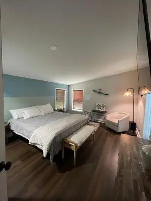 a bedroom with a large bed and a chair at Serenity away from the big city in Amelia