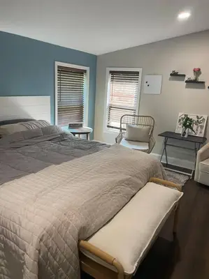 a bedroom with a large bed and a chair at Serenity away from the big city in Amelia