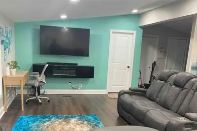 a living room with a couch and a flat screen tv at Serenity away from the big city in Amelia