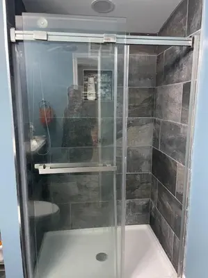 a shower with a glass door in a bathroom at Serenity away from the big city in Amelia