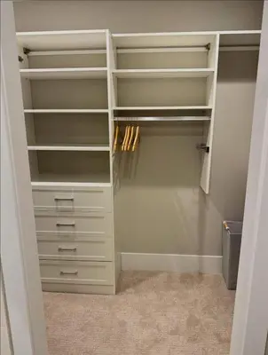 a walk in closet with white shelves and drawers at Mt Adams Adventure in Cincinnati