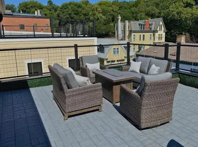 a patio with wicker chairs and a table on a roof at Mt Adams Adventure in Cincinnati