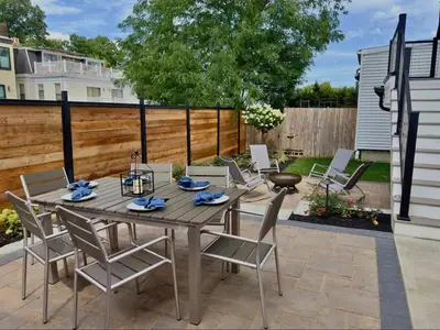 a patio with a wooden table and chairs at Mt Adams Adventure in Cincinnati