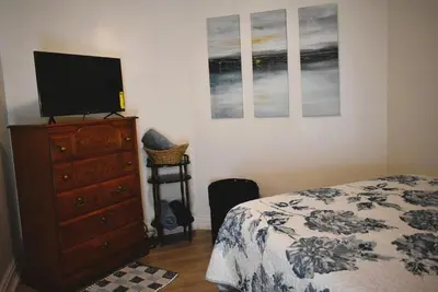 a bedroom with a bed and a dresser with a flat screen tv at Lima Downtown 1 Bdrm Oasis in Lima