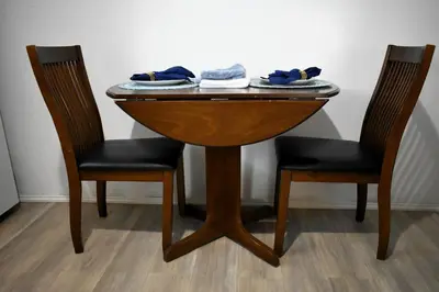 a wooden table with two chairs and a table with twosein at Lima Downtown 1 Bdrm Oasis in Lima