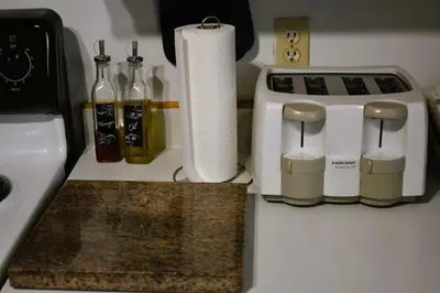 a kitchen counter with a toaster and rolls of paper towels at Lima Downtown 1 Bdrm Oasis in Lima