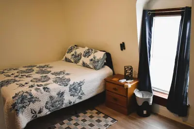 a small bedroom with a bed and a window at Spacious 2bdrm in Lima's Heart in Lima