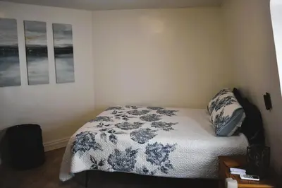 a bedroom with a bed with a blue and white blanket at Spacious 2bdrm in Lima's Heart in Lima