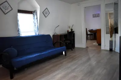a living room with a blue couch and a desk at Spacious 2bdrm in Lima's Heart in Lima