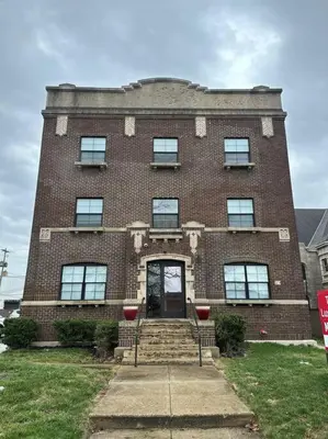a large brick building with a front door and stairs at Columbus Gem with Pool Table! Pets Welcome! in Columbus