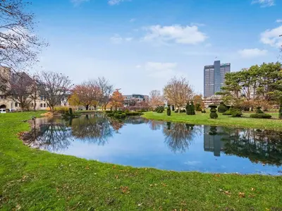 a pond in a park with a city in the background at Columbus Gem with Pool Table! Pets Welcome! in Columbus