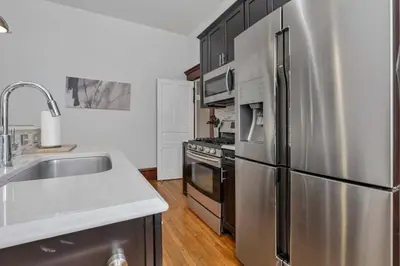 a kitchen with a stainless steel refrigerator and a sink at 4 Bed Townhome near Goodale Park in Columbus