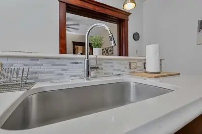 a stainless steel sink in a white kitchen at 4 Bed Townhome near Goodale Park in Columbus