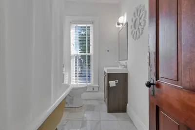 a bathroom with a tub and a toilet and a sink at 4 Bed Townhome near Goodale Park in Columbus