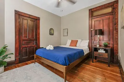 a bedroom with a bed and a wooden door at 4 Bed Townhome near Goodale Park in Columbus