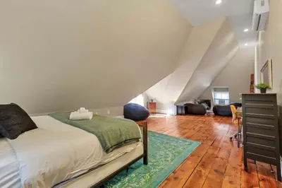 a bedroom with a bed and a staircase at 4 Bed Townhome near Goodale Park in Columbus