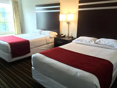 a hotel room with two beds and a window at The Inn in Monaca