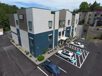 an aerial view of a hotel with cars parked in a parking lot at The Inn in Monaca