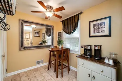 a kitchen with a table and a mirror at Antique Charm 3BR Gourmet Kitchen & Large Yard in Kettering
