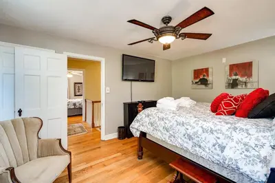 a bedroom with a bed and a ceiling fan at Antique Charm 3BR Gourmet Kitchen & Large Yard in Kettering