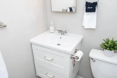 a white bathroom with a sink and a toilet at Modern 2BR Gem Steps to The Greene UD & WPAFB in Kettering