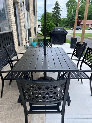 a black picnic table with chairs on a sidewalk at Modern 2BR Gem Steps to The Greene UD & WPAFB in Kettering