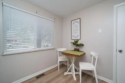 a dining room with a table and chairs and a window at Heart Day Deal Holiday Retreat Prime Location in Kettering