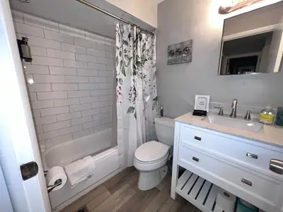 a bathroom with a toilet and a sink and a shower at Heart Day Deal Holiday Retreat Prime Location in Kettering