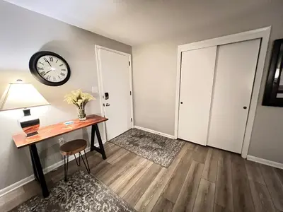 a room with a desk and a clock on the wall at Heart Day Deal Holiday Retreat Prime Location in Kettering