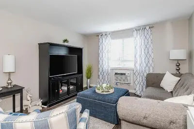 a living room with a couch and a flat screen tv at Modern Gem Steps from The Greene UD & WPAFB in Kettering