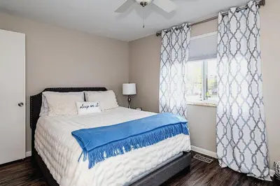 a bedroom with a bed and a window at Modern Gem Steps from The Greene UD & WPAFB in Kettering