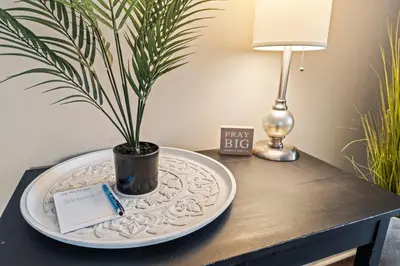 a table with a plate with a potted plant on it at Modern Gem Steps from The Greene UD & WPAFB in Kettering