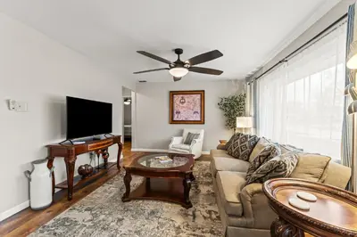 a living room with a couch and a tv at Close to The Greene, Escape Kalm Retreat in Kettering