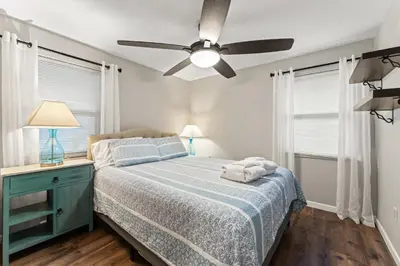 a bedroom with a bed and a ceiling fan at Close to The Greene, Escape Kalm Retreat in Kettering