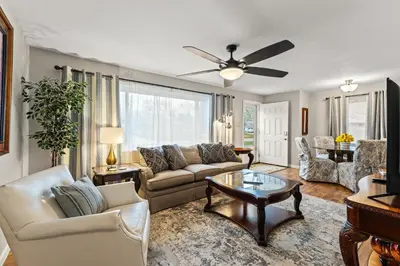 a living room with a couch and a table at Close to The Greene, Escape Kalm Retreat in Kettering