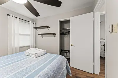 a bedroom with a bed with towels on it at Close to The Greene, Escape Kalm Retreat in Kettering