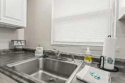 a kitchen counter with a sink and a window at Close to The Greene, Escape Kalm Retreat in Kettering