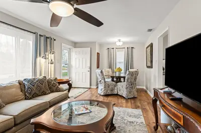 a living room with a couch and a flat screen tv at Close to The Greene, Escape Kalm Retreat in Kettering